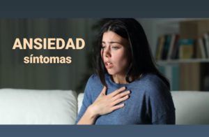 Mujer con la mano en el pecho respirando con dificultad, sobre los síntomas de la ansiedad